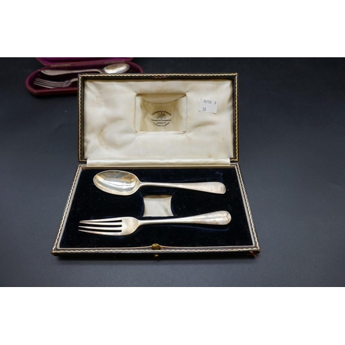 645 - A cased silver christening fork and spoon; together with a cased silver christening spoon; and anoth... 