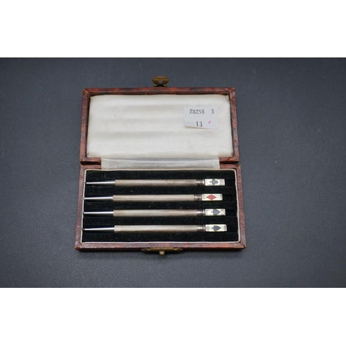 660 - A cased set of four novelty white metal and enamel bridge pencils, stamped Sterling, each 87mm.... 