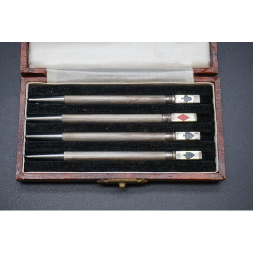 660 - A cased set of four novelty white metal and enamel bridge pencils, stamped Sterling, each 87mm.... 