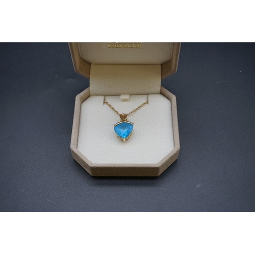 673 - A yellow metal pendant, set heart shaped blue topaz, approx 9ct and a brilliant cut diamond approx 0... 