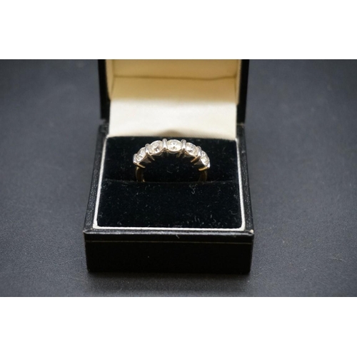 679 - An 18ct white and yellow gold diamond five stone half eternity ring, set five brilliant cut diamonds... 