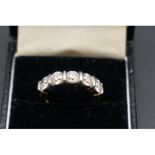 679 - An 18ct white and yellow gold diamond five stone half eternity ring, set five brilliant cut diamonds... 