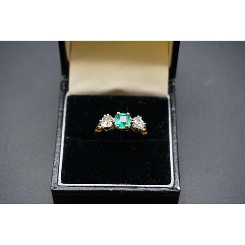 684 - A yellow metal emerald doublet and diamond three stone ring, stamped 18ct, size O.