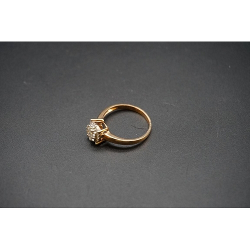 686 - A yellow metal diamond cluster ring, stamped 750, size O.