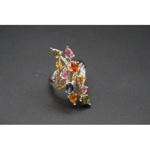 687 - An 18ct white gold cocktail ring set coloured gemstones, size O.