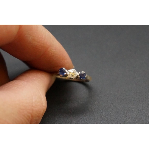 688 - A yellow metal diamond and sapphire three stone ring, the central diamond approx 0.25ct, stamped 18c... 