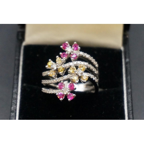 690 - An 18ct gold diamond and gem set floral three band ring, size N1/2.