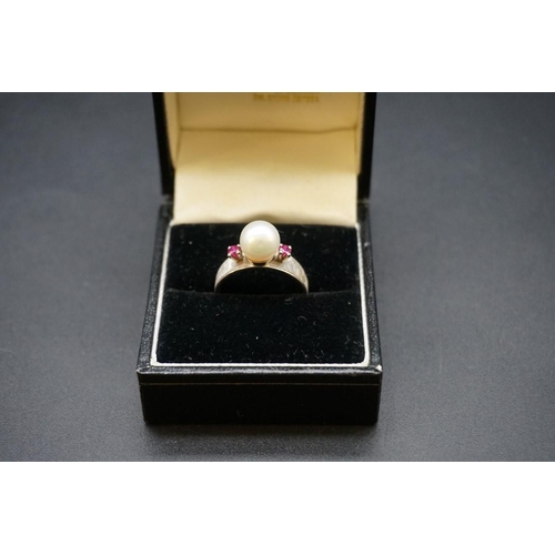 693 - A pearl and ruby three stone ring, stamped 14k, size M1/2.