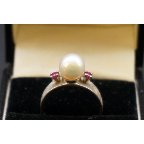 693 - A pearl and ruby three stone ring, stamped 14k, size M1/2.