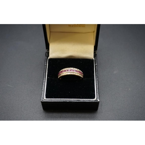 694 - A yellow metal ruby and diamond half eternity ring, size O.