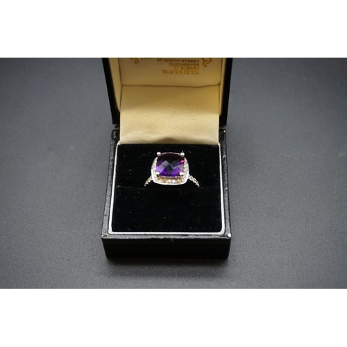 697 - A white metal amethyst and diamond cluster ring, stamped 585 size O.