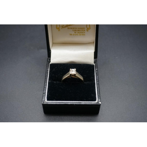 702 - A white metal diamond solitaire ring, approx 0.35ct, stamped 18k, size M1/2.