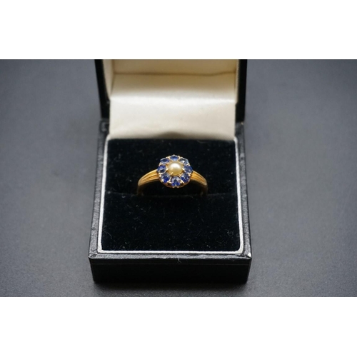 703 - A yellow metal pearl and sapphire cluster ring, stamped 18ct, size P.