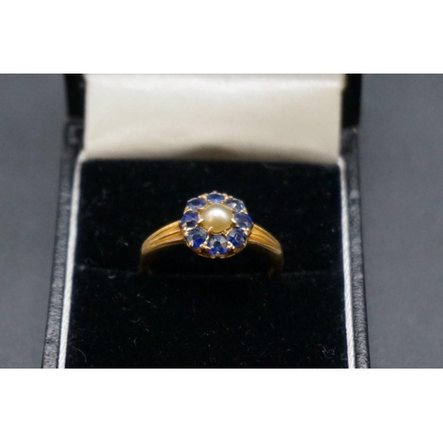 703 - A yellow metal pearl and sapphire cluster ring, stamped 18ct, size P.