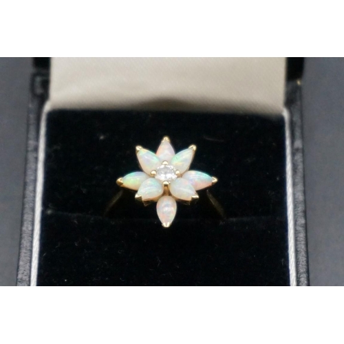 705 - An 18ct gold diamond and opal floral cluster ring, size N1/2; together with a similar pair of ear st... 