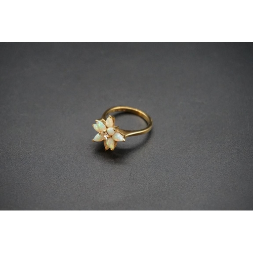 705 - An 18ct gold diamond and opal floral cluster ring, size N1/2; together with a similar pair of ear st... 