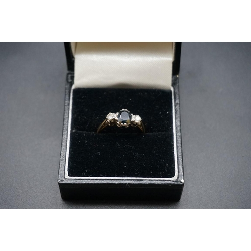 709 - A yellow metal sapphire and diamond three stone ring, stamped 18ct, size J.