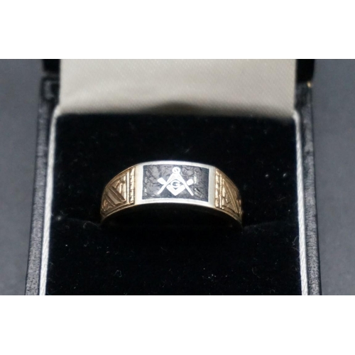 710 - A two tone yellow metal and black enamel Masonic signet ring, stamped 10k, size U.