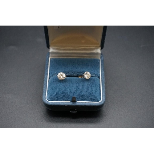 715 - A pair of brilliant cut diamond ear studs, estimated at 0.5ct each.