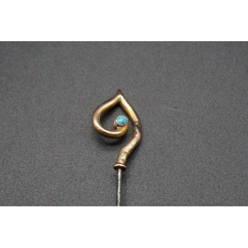 718 - An Arts and Crafts hat pin, by Murrle, Bennett & Co, having yellow metal turquoise set terminal ... 