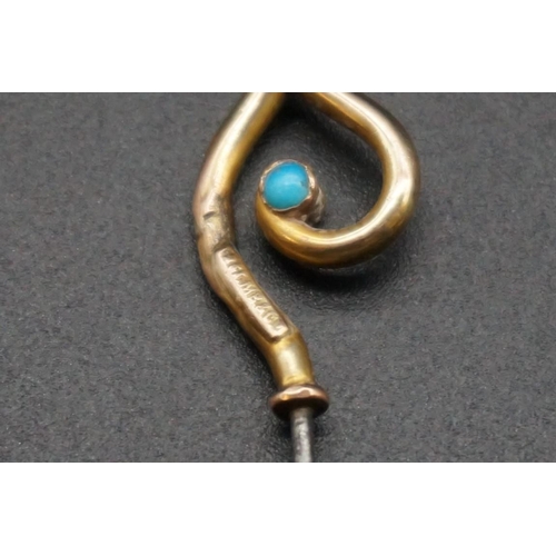 718 - An Arts and Crafts hat pin, by Murrle, Bennett & Co, having yellow metal turquoise set terminal ... 