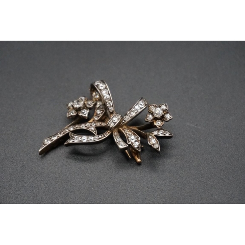 720 - A yellow and white metal diamond set floral spray brooch, 43mm.