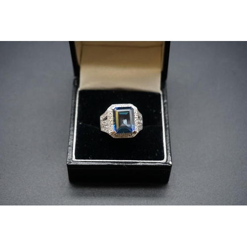 728 - A 14ct white gold ring, set rectangular facetted blue gemstone and small diamonds, size N.... 