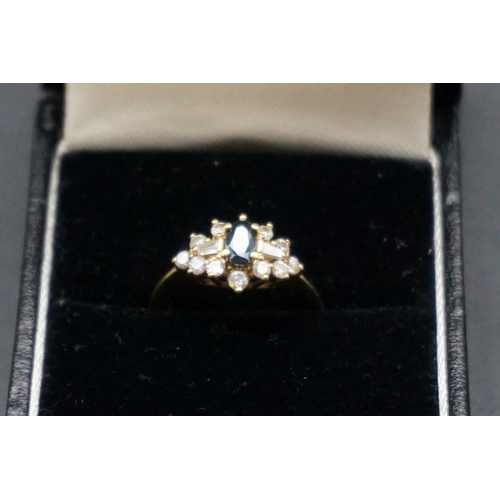 730 - A yellow metal sapphire and diamond ring, stamped 18ct 750, set central sapphire surrounded by twelv... 