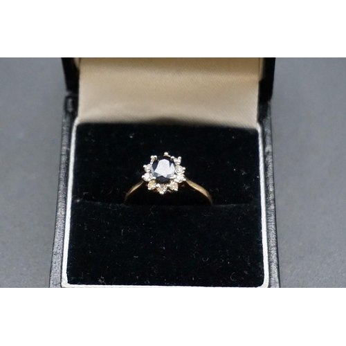 733 - A yellow metal sapphire and diamond cluster ring, stamped 14k, Size L.