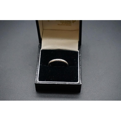 736 - A wedding band, stamped platinum, size M.