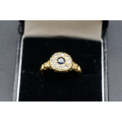 737 - An 18ct gold sapphire and diamond floral cluster ring, hallmark London 1928, size O1/2.... 