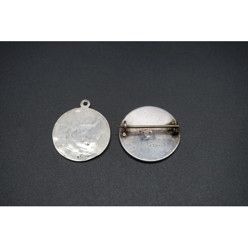 745 - A white metal golf badge, 28mm diameter; together with another Art Nouveau white metal pendant, stam... 