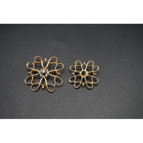 747 - Two 9ct gold openwork floral brooches, one set a diamond to centre and the other set a sapphire to c... 