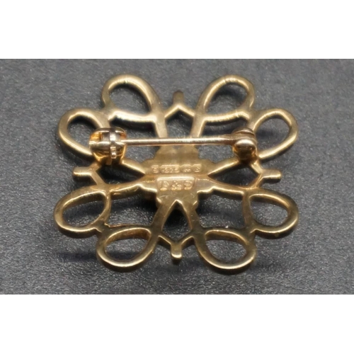 747 - Two 9ct gold openwork floral brooches, one set a diamond to centre and the other set a sapphire to c... 