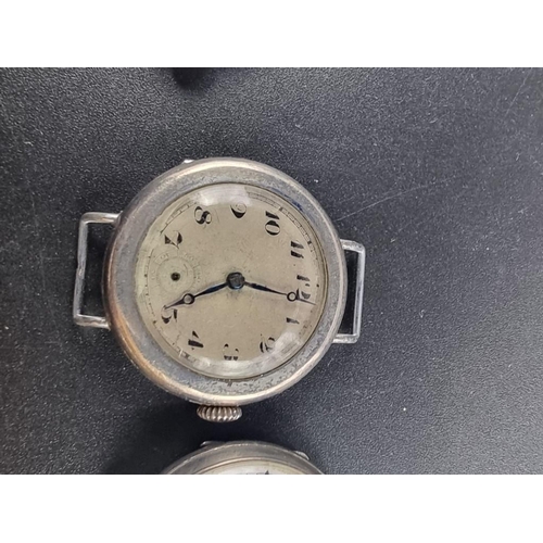 972 - Three various WWI silver manual wind trench watches; together with another silver wristwatch. (4)... 