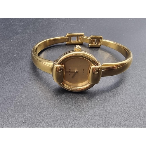 984 - A 1990s Gucci gold tone stainless steel quartz ladies bangle watch, 25mm, Ref. 1400L, Serial no. 012... 