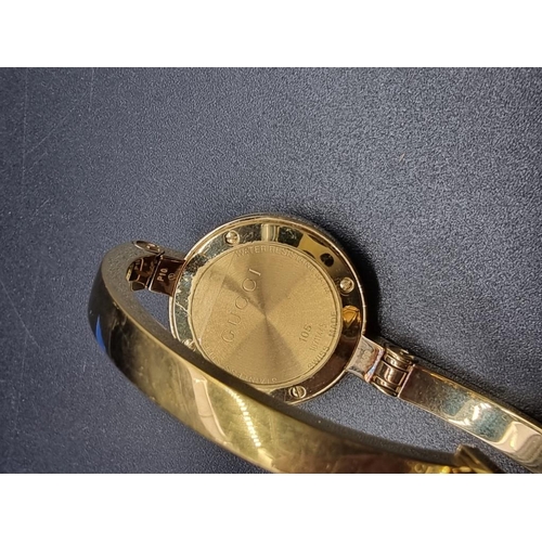 985 - A circa 2009 Gucci 105 gold plated ladies quartz wristwatch, 26mm.