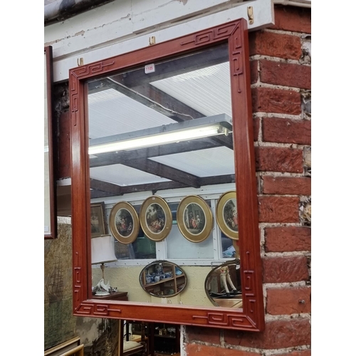 1105 - A Chinese hardwood framed wall mirror, 76 x 61cm. 