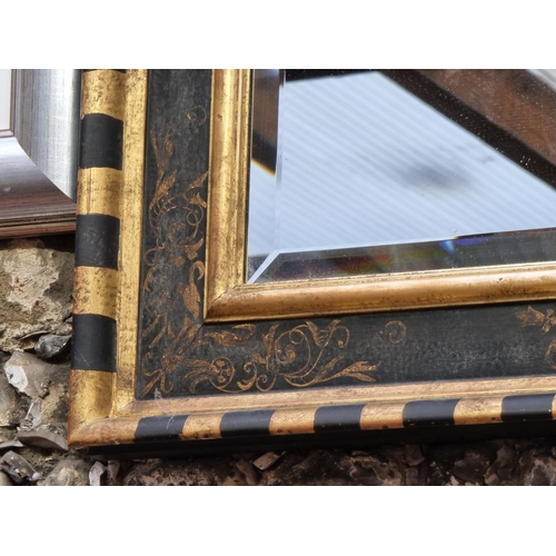 1108 - An ebonized and parcel gilt framed rectangular wall mirror, 79.5 x 64.5cm.