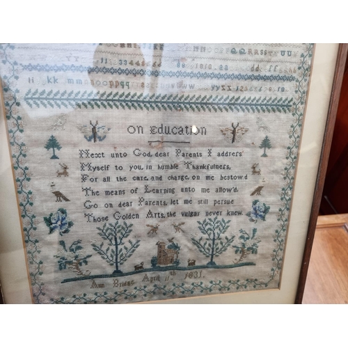 1140 - A William IV needlework sampler, by 'Ann Bridge, April 11th, 1831', 40.5 x 32cm, (moth damage).... 