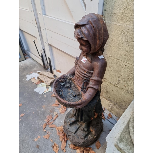 1149 - An old cast iron figure of a Dutch girl, 90cm high. 