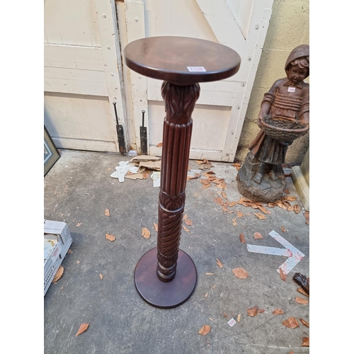 1158 - A carved mahogany 'bedpost' torchere, 102cm high. 