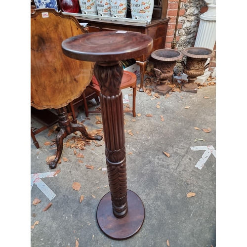 1158 - A carved mahogany 'bedpost' torchere, 102cm high. 