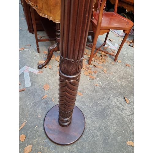 1158 - A carved mahogany 'bedpost' torchere, 102cm high. 