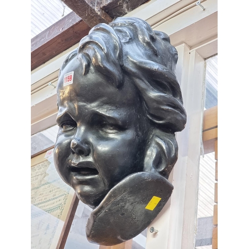 1159 - A large painted plaster bust of a child, 39cm high.