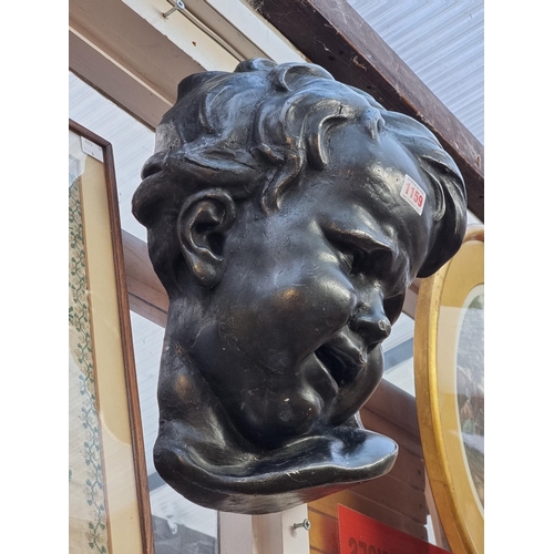 1159 - A large painted plaster bust of a child, 39cm high.