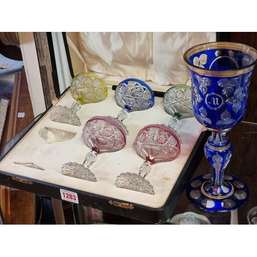 1283 - A good 19th century blue overlaid glass goblet, 23.5cm high; together with a cased part set of five ... 