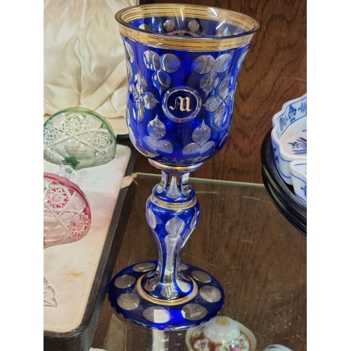 1283 - A good 19th century blue overlaid glass goblet, 23.5cm high; together with a cased part set of five ... 