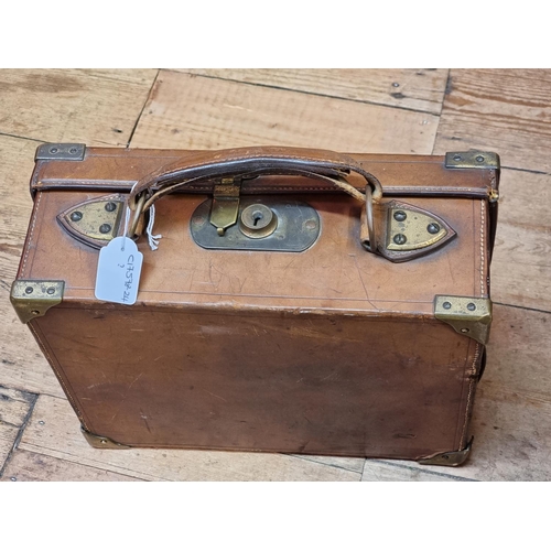 1701 - An old tan leather and brass bound cartridge case, (now with void interior), 33cm wide. ... 