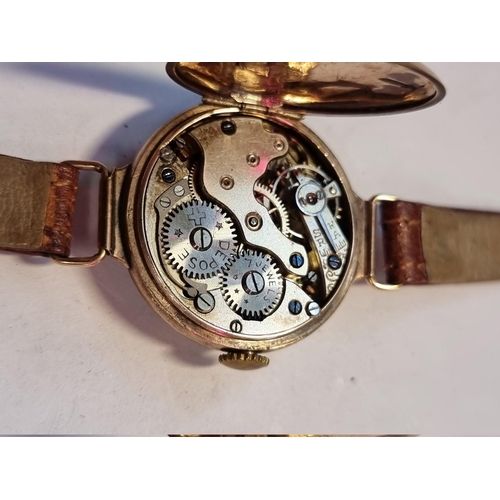 990 - A 9ct gold ladies manual wind wristwatch, on brown leather strap.